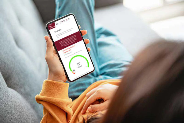 Woman looks at smartphone showing results of Immune System Deficiency Test