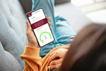 Woman looks at smartphone showing results of Iodine Test